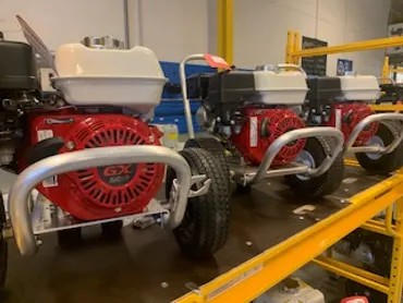 Row of gas pressure washers on display racks