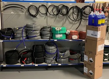 Wall of pressure washer hoses and reels