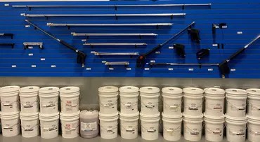 Wands and lances on the wall above chemical pails